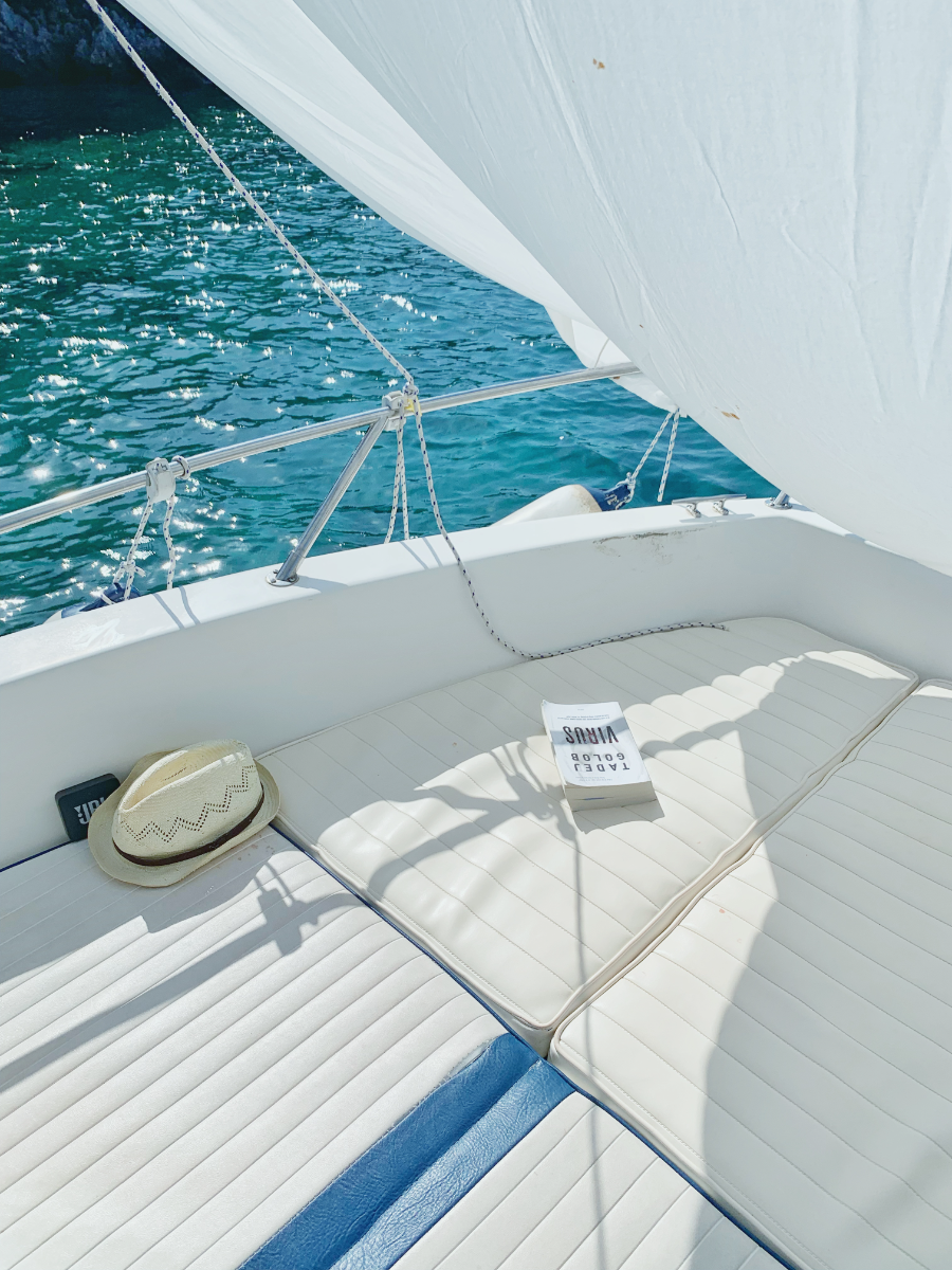 A sailboat overlooking clear blue water